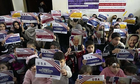 fghan refugees hold placards during their meeting to discuss situation after President Donald Trump paused the U.S. refugee programs, in Islamabad (AP)