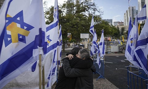 Two women embrace at the so-called Hostages Square in Tel Aviv (AP)