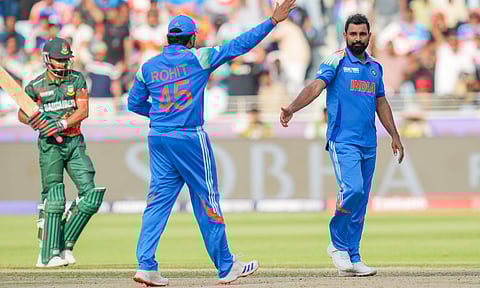 ndia's Mohammed Shami, right, celebrates with captain Rohit Sharma after taking the wicket of Bangladesh's Tanzim Hasan Sakib during a ODI match (PTI)&nbsp;