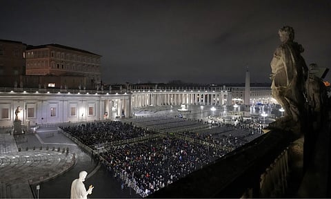 People attend a rosary prayer service held for the health of Pope Francis in St Peter's Square at The Vatican (AP)