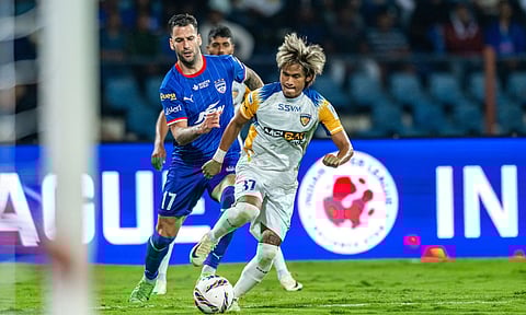Chennaiyin's Jiteshwor Singh dribbles the ball past Bengaluru's Edgar Mendez