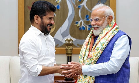 Prime Minister Narendra Modi being greeted by Telangana Chief Minister Revanth Reddy during meeting, in New Delhi