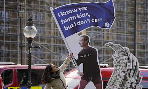 A protestor at an installation outside Westminster in London in October 2021, shortly before Facebook whistleblower Frances Haugen testified about the company’s pursuit of profit. (AP)