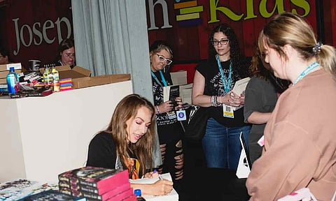 Sophie Lark at a book festival. After receiving criticism, Lark said she would revise the book “to ensure that my work doesn’t contribute to harm.” (Credit: Morgan Hornsby for The New York Times)