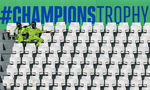 Even these two who are 'watching' the match at Gaddafi Stadium are actually ground staff waiting for it all to get over (AFP)&nbsp;