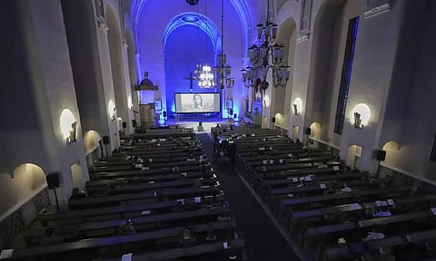 People watch an Al-created service at St. Paul's Lutheran church in Helsinki, Finland (AP)