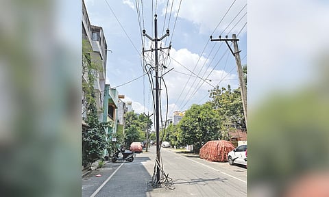 Residents of KKR Nagar in Madhavaram are worried about electric posts with dangling cables right in middle of road