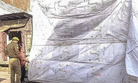 The Shahi Jama Masjid being covered in tarpaulin as prevention against possible holi colour ahead of the celebration, in Sambhal, Uttar Pradesh, Credit: PTI Photo

