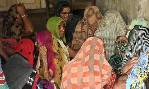 Family members and relatives mourn outside the residence of Pradipkumar Patel and his daughter who were shot dead at a convenience store in the US state of Virginia, in Mehsana district, Gujarat (PTI)