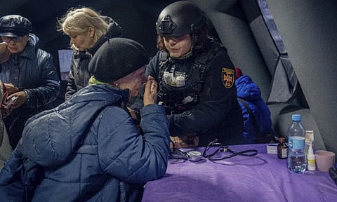 A psychologist works with residents of houses which were hit by a Russian attack in Sumy, Ukraine (AP)