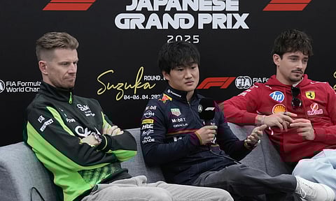 Red Bull driver Yuki Tsunoda of Japan, center, flanked by Kick Sauber driver Nico Hulkenberg of Germany, left, and Ferrari driver Charles Leclerc of Monaco, responds to a journalist's question during a news conference at the Suzuka Circuit (AP)
