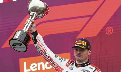 Red Bull driver Max Verstappen celebrates with his trophy on the podium after the Japanese Formula One Grand Prix (AP)