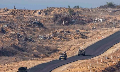 &nbsp;Israeli military vehicles move inside the Gaza Strip, as seen from southern Israel (AP)