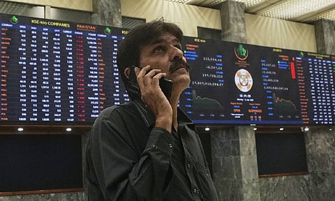 An investor looks on indexes and benchmark 100 index at the Pakistan stock Exchange (PSE), in Karachi, Pakistan (AP)&nbsp;