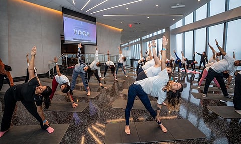 People perform yoga during a speacial '75 days to go' yoga session, a countdown to the 11th International Day of Yoga that will be commemorated globally on June 21, at the iconic World Trade Centre in New York (PTI)