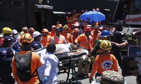 Rescue workers carry a person pulled from the wreckage of the Jet Set nightclub after its roof collapsed during a merengue concert in Santo Domingo, Dominican Republic (AP)