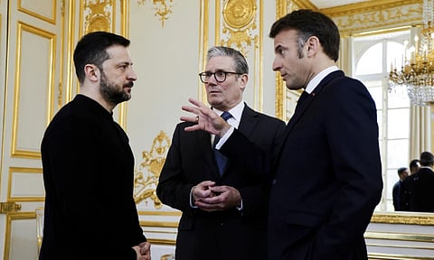 Volodymyr Zelenskyy, left, French President Emmanuel Macron, right, and Britain’s Prime Minister Keir Starmer speak during a trilateral meeting