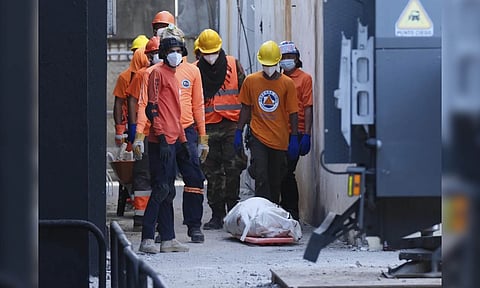 Rescue workers stand next to a recovered body of a victim who died when the roof collapsed two nights prior at the Jet Set nightclub during a merengue concert, in Santo Domingo, Dominican Republic, Wednesday, April 9, 2025 (AP)&nbsp;