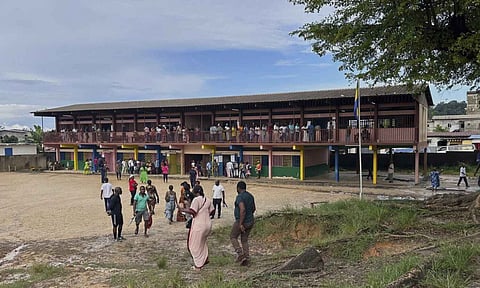 Voters queue to cast their votes for the presidential elections outside a polling station, in Liberville, Gabon (AP)