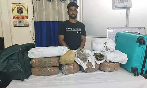 The arrested Saranraj with 15 kg of seized ganja (Daily Thanthi)
