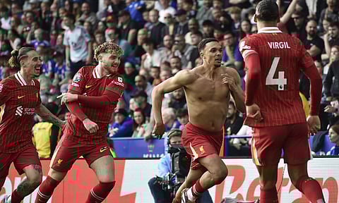 Liverpool's Trent Alexander-Arnold, second right, celebrates after scoring his side's opening goal during the English Premier League soccer match between Leicester City and Liverpool (AP)