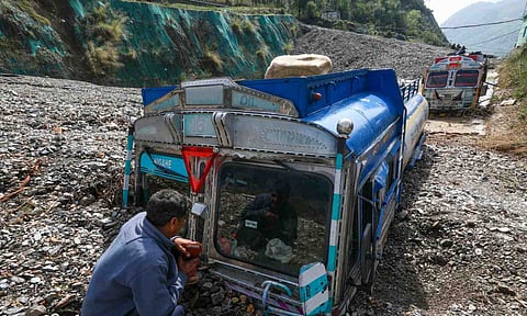 Vehicles stuck in debris after landslides and flash flood following heavy rainfall, in Ramban district, Jammu and Kashmir, Monday (PTI)