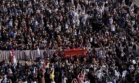 The ceremony with the Pope Francis' body, who will lie in state at St. Peter's Basilica for three days, pass through the crowd at the Vatican, Wednesday, April 23, 2025 (AP)