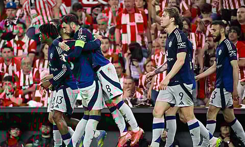 Manchester United players celebrate after scoring a goal