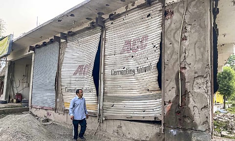 A civilian looks at damaged properties after heavy firing and shelling by Pakistan military overnight across the Line of Control and International Border, at Mendhar area of Poonch district, Jammu and Kashmir (PTI)