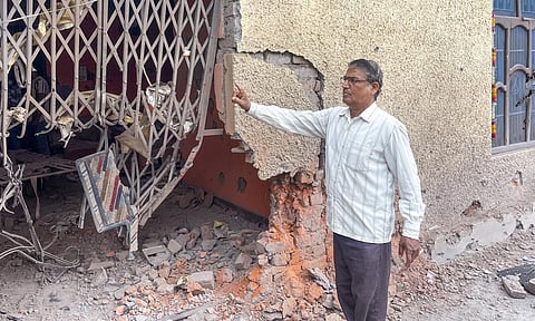 A civilian looks at damaged properties after heavy firing and shelling by Pakistan military overnight across the Line of Control and International Border, at Mendhar area of Poonch district, Jammu and Kashmir, Wednesday, May 7, 2025 (PTI)&nbsp;