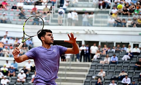 Carlos Alcaraz returns to Karen Khachanov during the match