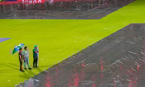 Officials inspect the ground as it rains before an Indian Premier League (IPL) 2025 T20 cricket match between Royal Challengers Bengaluru and Kolkata Knight Riders, at the M Chinnaswamy Stadium (PTI)