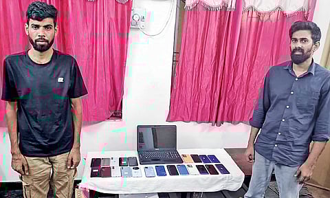 Accused with seized mobile phones and a laptop&nbsp;