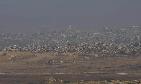 Destroyed buildings in the Gaza Strip are seen from southern Israel (AP)