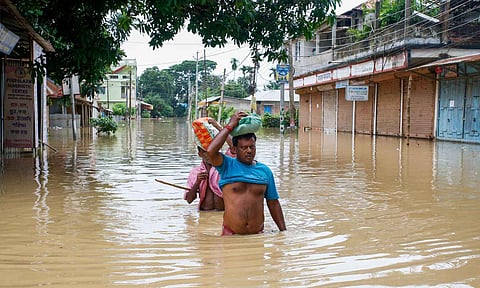 Flood-affected villagers are moved to a safer place after heavy rains at Baldakhal village on the outskirts of Agartala (PTI)