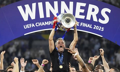 PSG's head coach Luis Enrique celebrates with the trophy after the Champions League final soccer match between Paris Saint-Germain and Inter Milan at the Allianz Arena in Munich, Germany, Saturday, May 31, 2025 (AP)&nbsp;