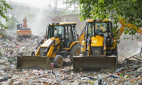 Bulldozers raze slum structures at Madrasi Camp in Jangpura amid heavy security deployment, following court demolition orders, in New Delhi (PTI)&nbsp;
