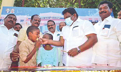 Minister SS Sivasankar distributing cakes to people in Ariyalur on Tuesday
