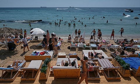 People sunbathing on the beach along the Mediterranean Sea in Batroun, northern Lebanon, May 31, 2025 (AP)