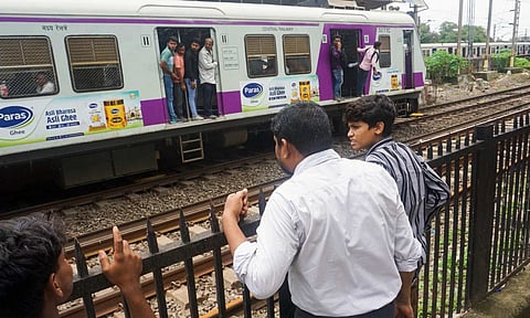 Police personnel at the Mumbra Railway Station after several passengers reportedly fell from a moving train, resulting in four deaths and multiple injuries, in Thane (PTI)