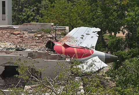 A damaged part of the Air India plane that crashed moments after taking off from the airport, lies on a residential building in Ahmedabad (PTI)
