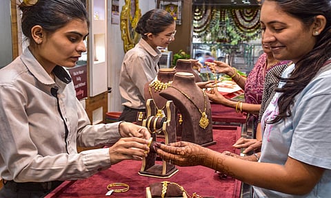 A customer buys jewellery at a showroom ahead of Akshaya Tritiya festival, in Surat, Monday, April 28, 2025 (PTI)