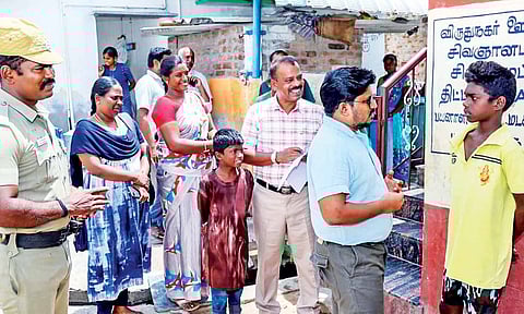 Collector VP Jeyaseelan interacts with a school dropout in Virudhunagar, on Saturday&nbsp;