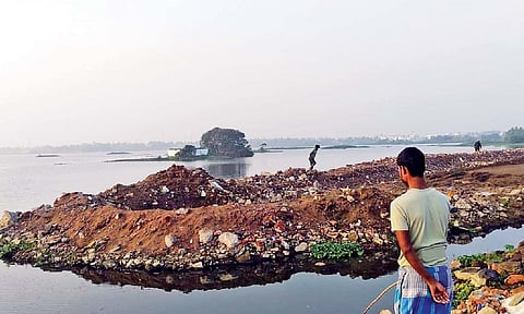 Construction debris and other waste dumped on the Madambakkam lake