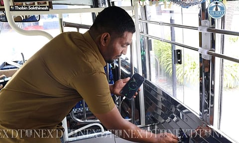 Crew member charging mobile phone in the new launched Private mini bus services (Photo: Thabin Sakthinesh)