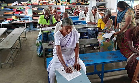 Elderly men and women attend a literacy test at an NILP centre in Cuddalore