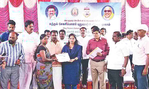 Mayor R Priya handing over identity card to a ragpicker on Saturday.