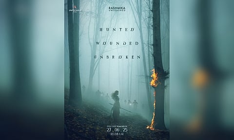 The poster that Rashmika shared had her holding a double-edged spear and standing next to a burning tree. (Photo: IANS)