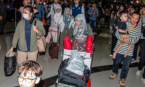 Indonesian nationals evacuated from Iran arrive at the Soekarno-Hatta International Airport in Tangerang (AFP)