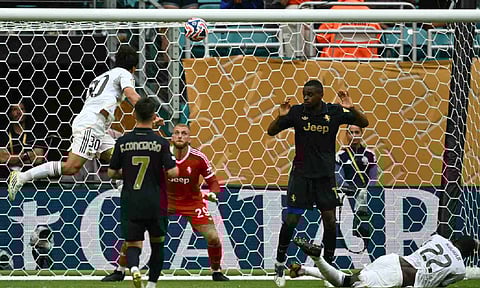 Gonzalo Garcia (Top-L) heads the ball to score for Madrid
